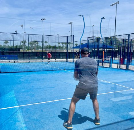 Two players training on a padel court in Orlando, FL