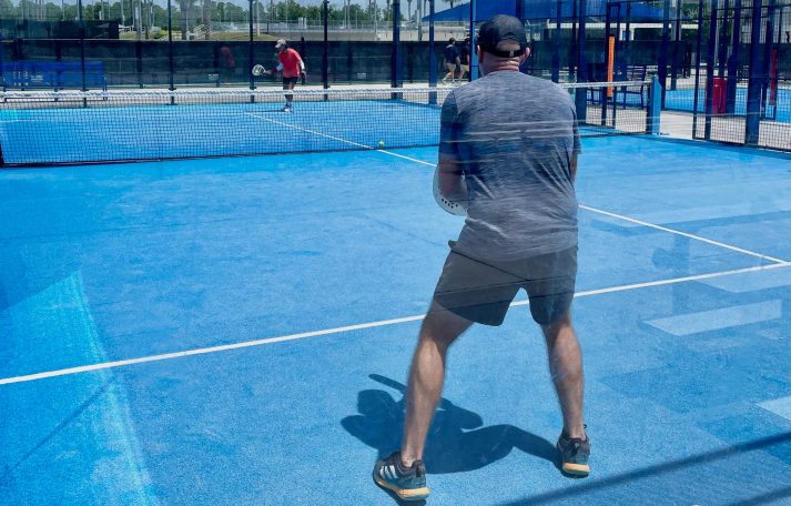 Two players training on an outdoor padel court in Orlando, FL